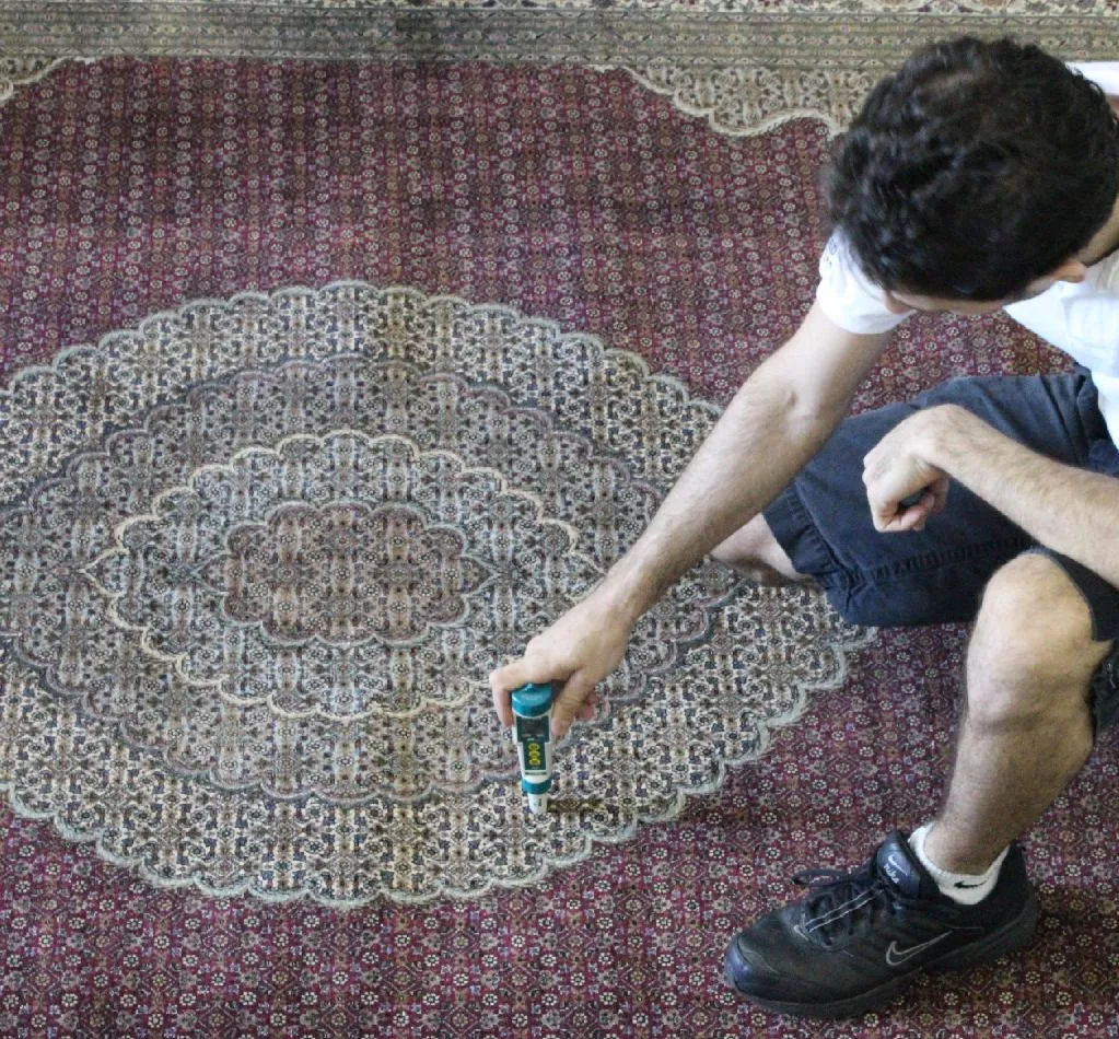 Close-up of a pH meter reading a rug during dye-stability testing